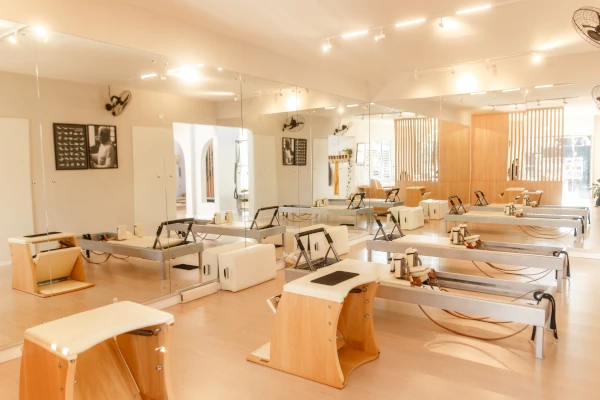 Fotografia do interior do estúdio Suzana Bond Pilates mostrando extensa variedade de equipamentos